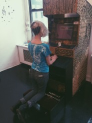 Feminist Confessional arcade cabinet with prayer bench