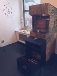 Feminist Confessional arcade cabinet with prayer bench